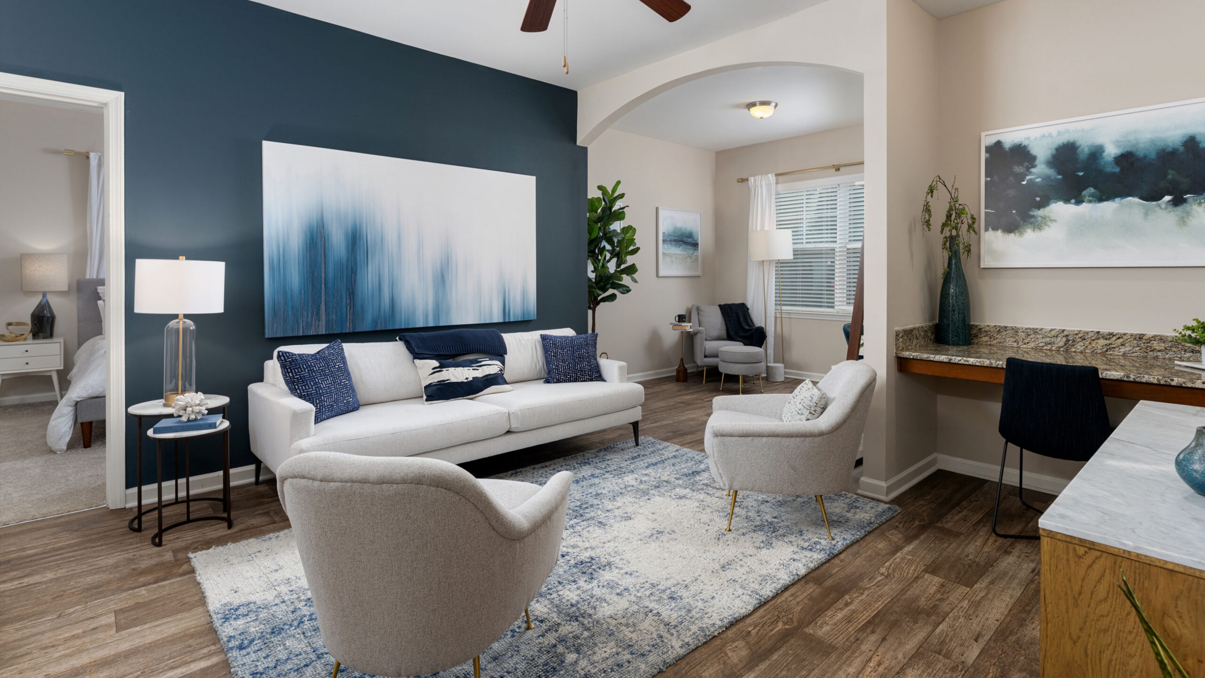 Hawthorne at Murrayville apartment living room furnished with white couches and elegant decoratio