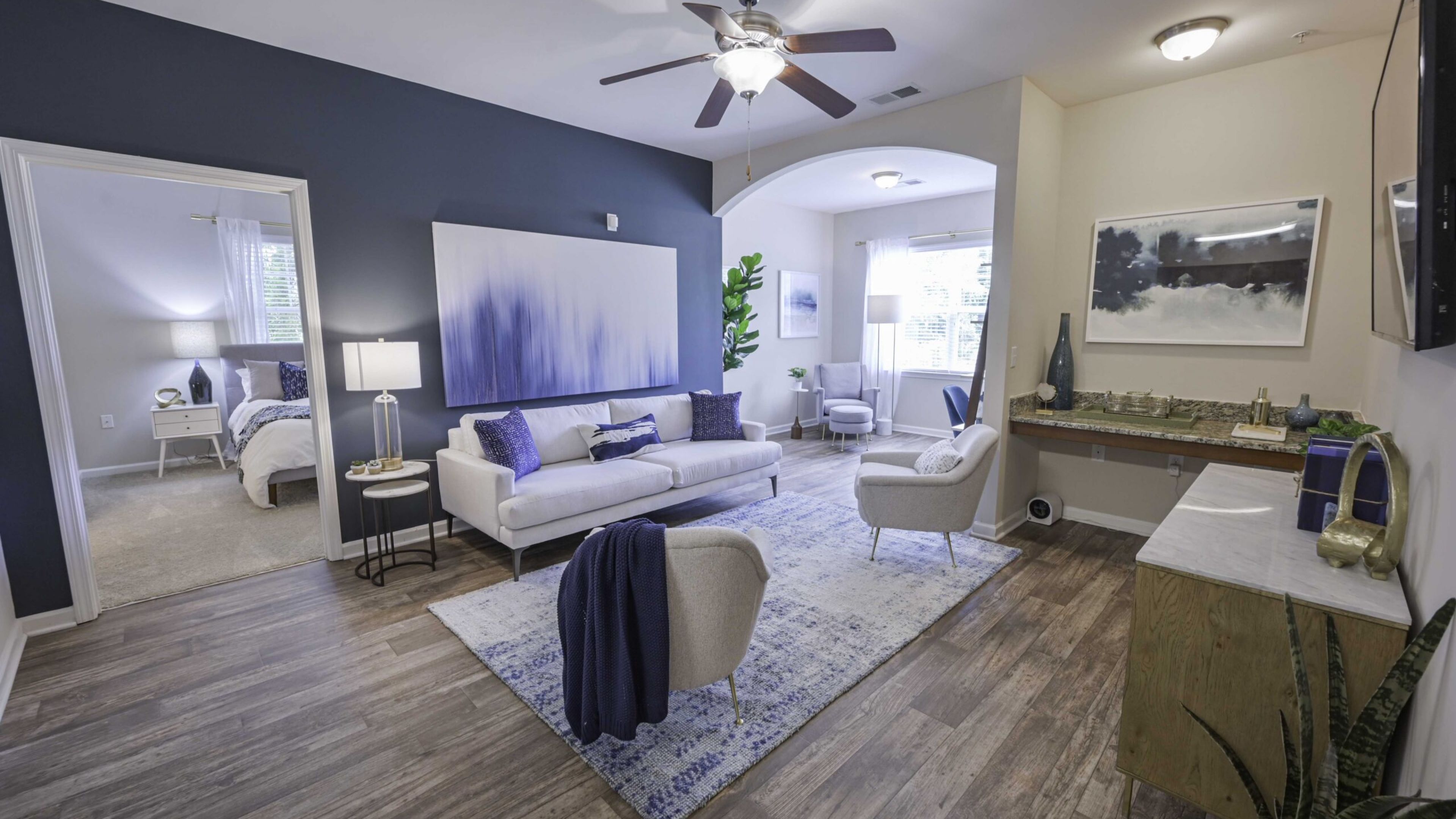 Hawthorne at Murrayville apartment living room furnished with white couches and elegant decoratio